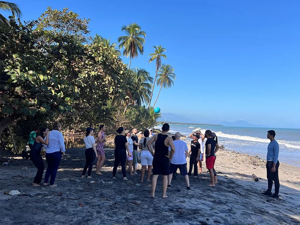Grupo de visitantes en la playa privada de La Jorará durante un pasadía